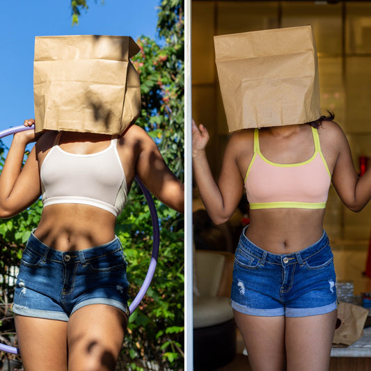 Two images of a person wearing a paper bag over their head, one outdoors and one indoors. Each wearing a qiwion jumpstart bra in different colours, paired with shorts. 