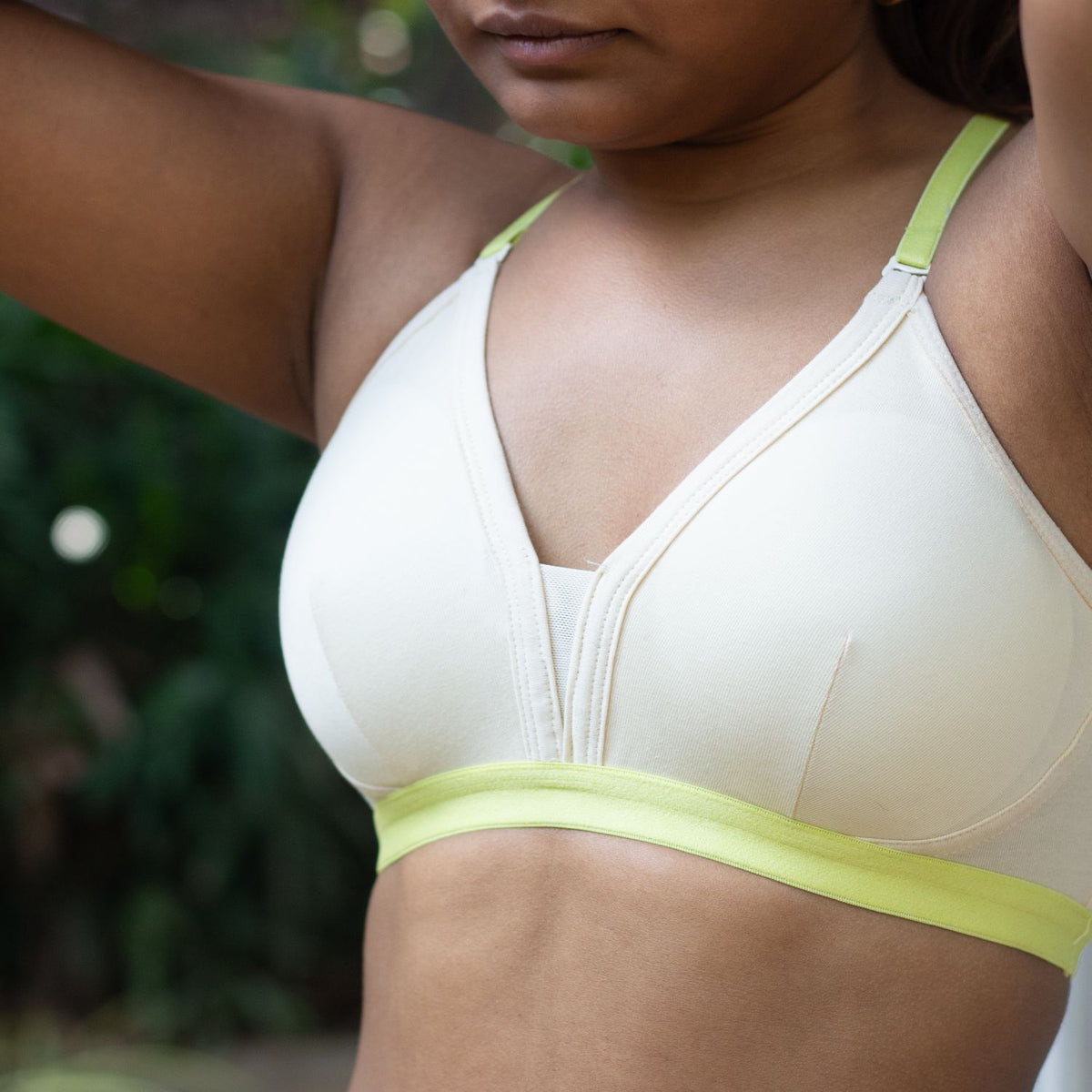 Woman wearing Qiwion Mood bra in cream with neon straps