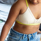 Person wearing cream Qiwion Mood bra with neon adjustable straps