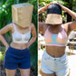 Two people wearing qiwion one and done bras and shorts outdoors with different head coverings.