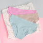 Three pairs of underwear in pink, blue, and light grey on a pink surface with a gray background.
